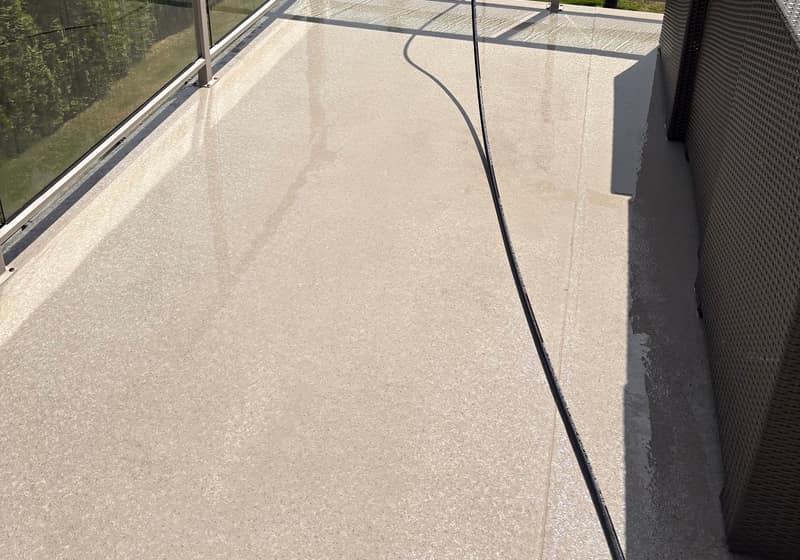 Balcony surface after pressure washing at a marina-view home
